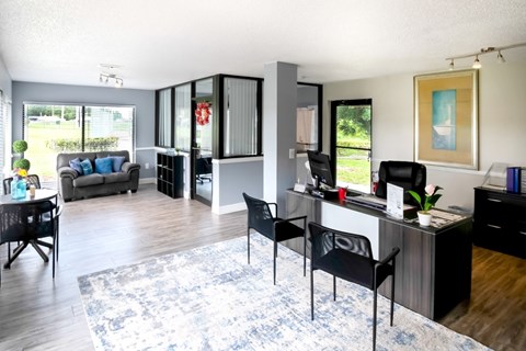 the view of a living room with a desk and a couch